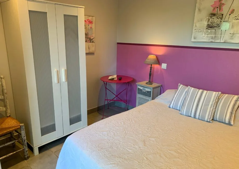 Representative hotel space: A bedroom with a bed, wardrobe, and bedside lamp.