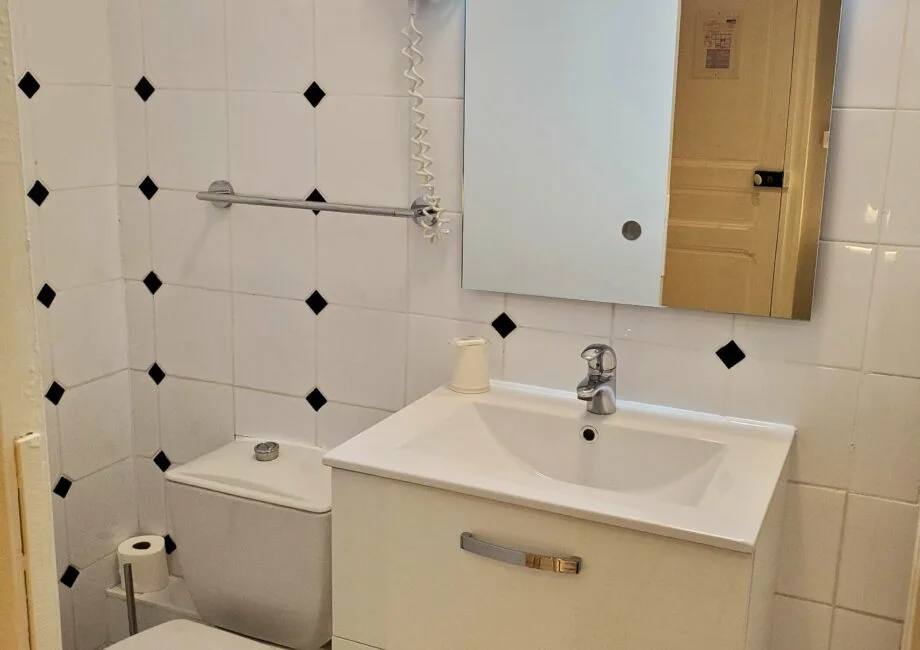 Representative hotel space: A bathroom with a sink, mirror, and toilet.