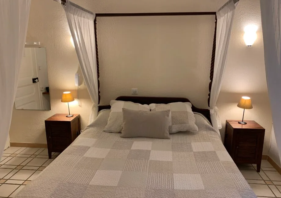 Representative hotel space: A bedroom with a neatly made bed and matching bedside tables.