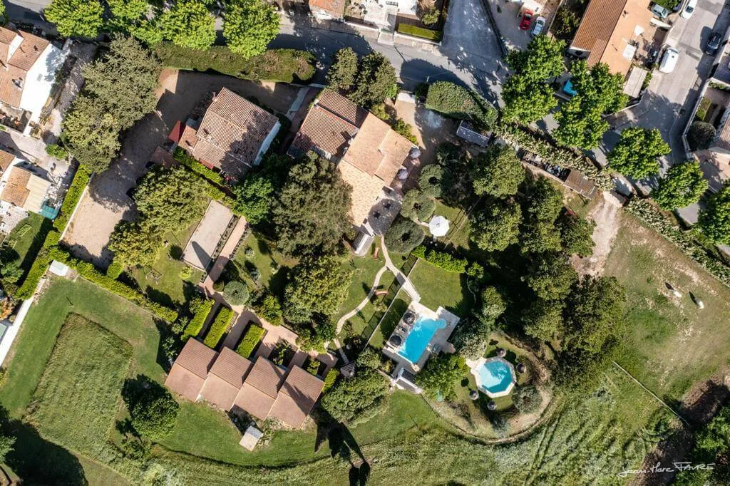 Representative hotel space: Aerial view of a landscaped property with buildings, trees, and a swimming pool.