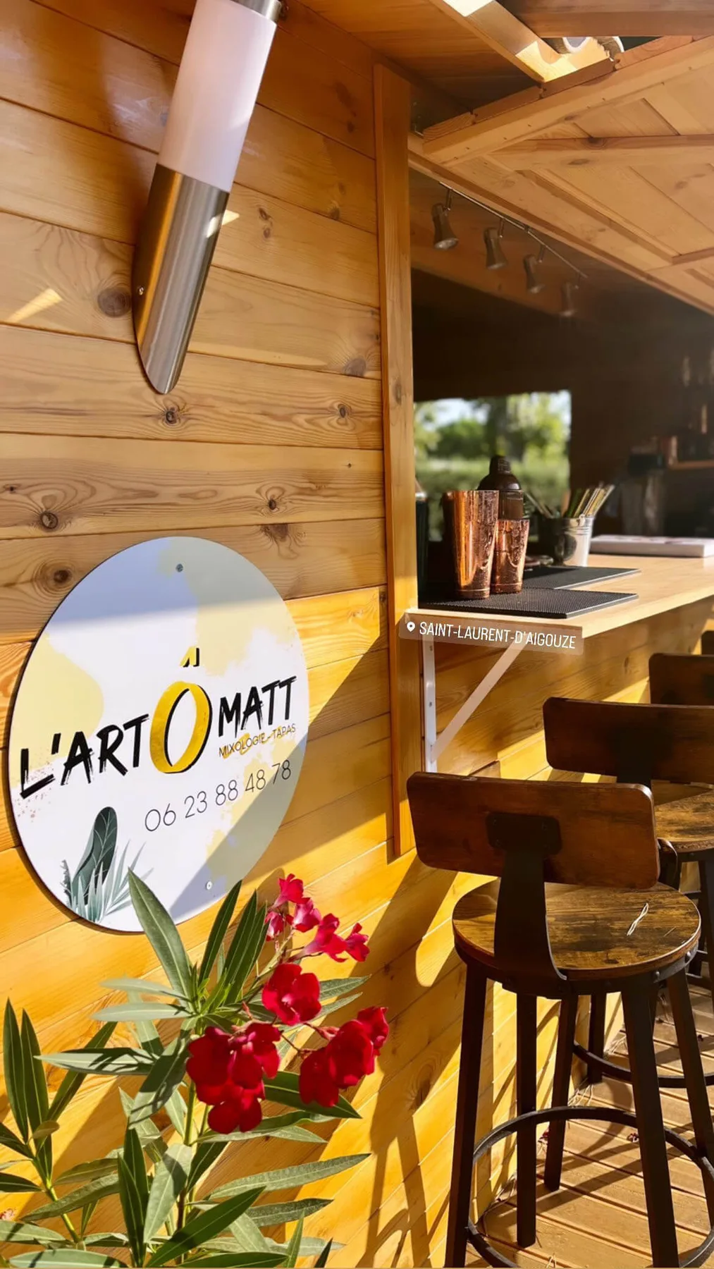 Representative hotel space: A wood-paneled bar area with counter seating and a vase of flowers.