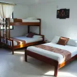 Representative hotel space: A bedroom with a bunk bed and a separate bed.