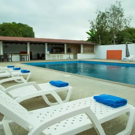 Representative hotel space: An outdoor swimming pool beside a shaded seating area.