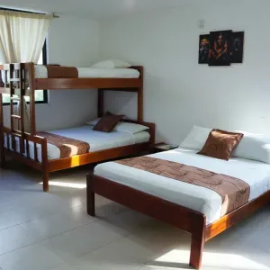 Representative hotel space: A bedroom with a wooden bunk bed and a separate bed.