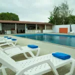 Representative hotel space: Outdoor pool area with white lounge seating.