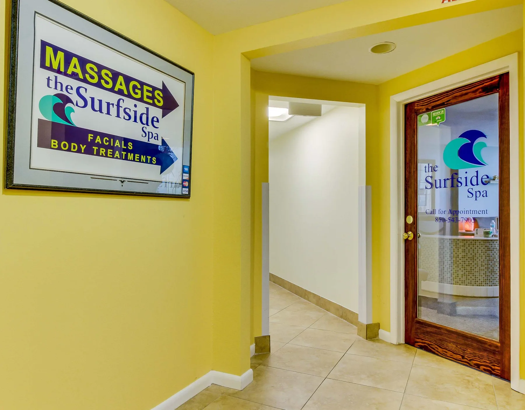 Shared amenity: A yellow hallway leads to a glass door with a spa sign.
