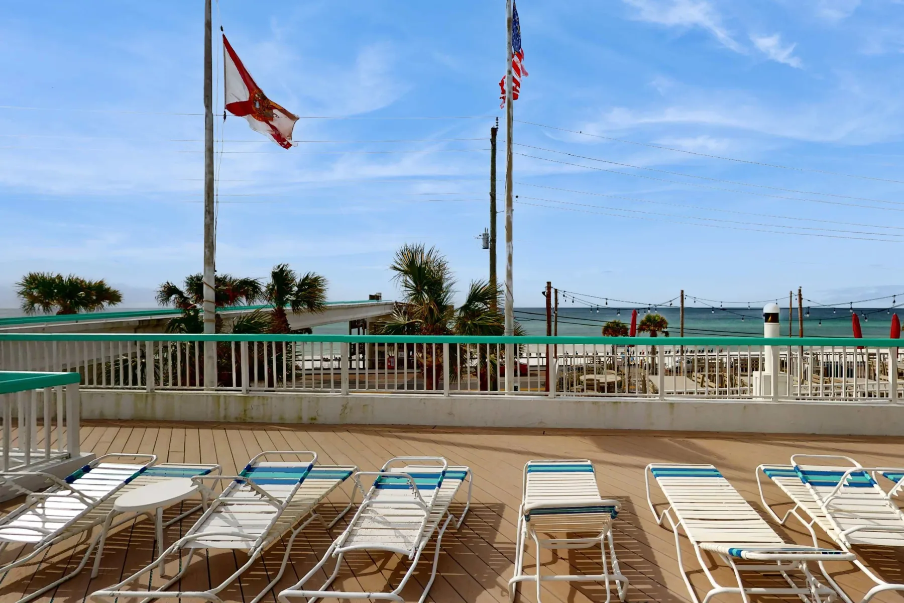 Shared amenity: A poolside deck with rows of lounge chairs overlooking the water.