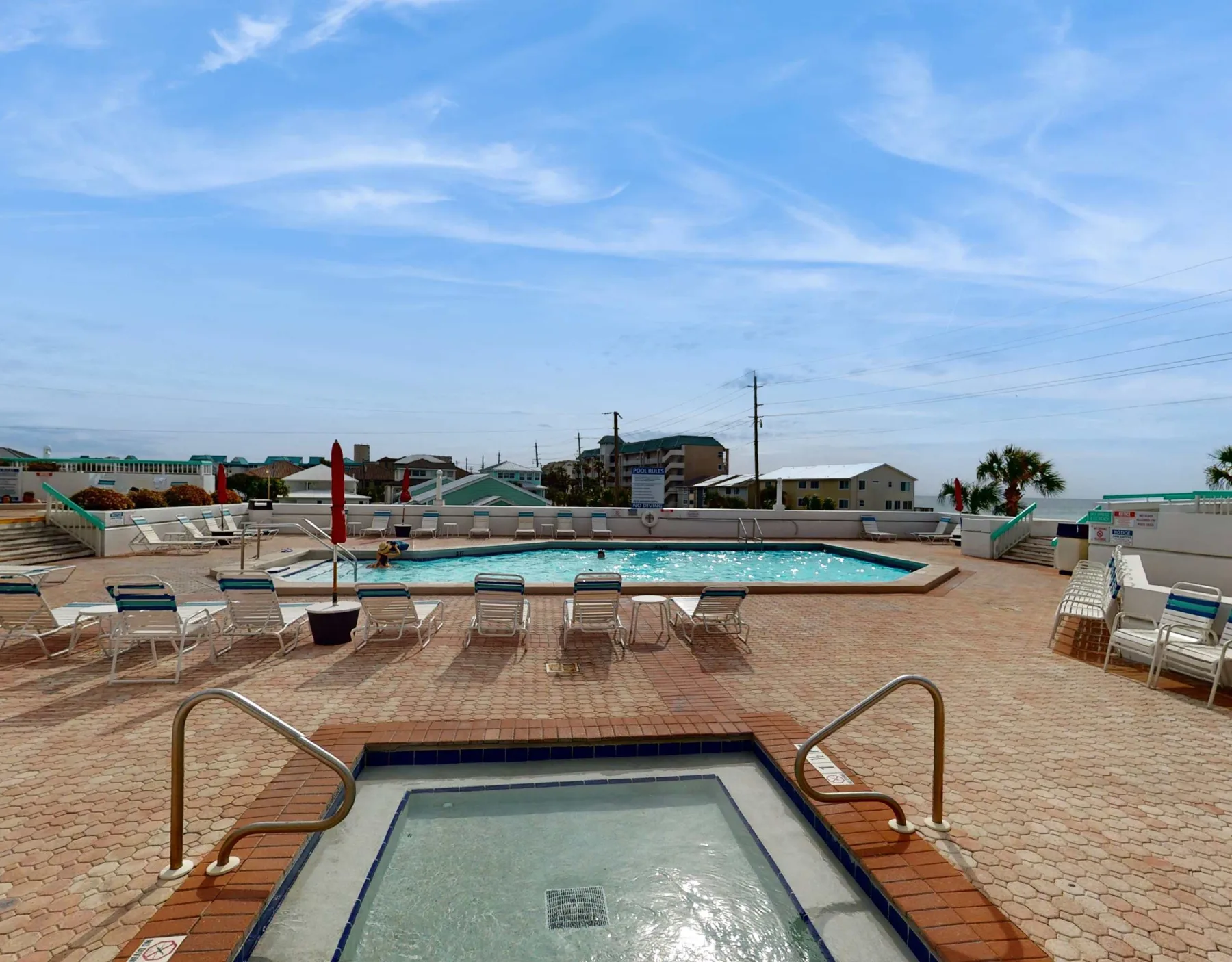 Shared amenity: An outdoor pool deck with lounge seating and a small pool in the foreground.