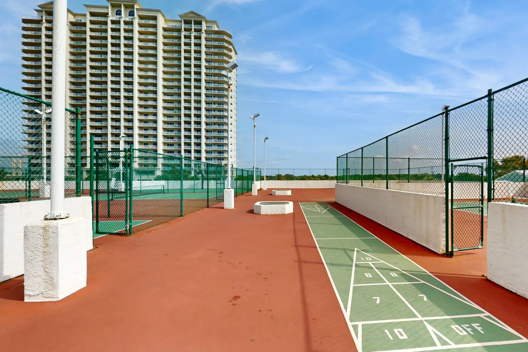 Shared amenity: An outdoor sports court with painted game lines and surrounding fencing.