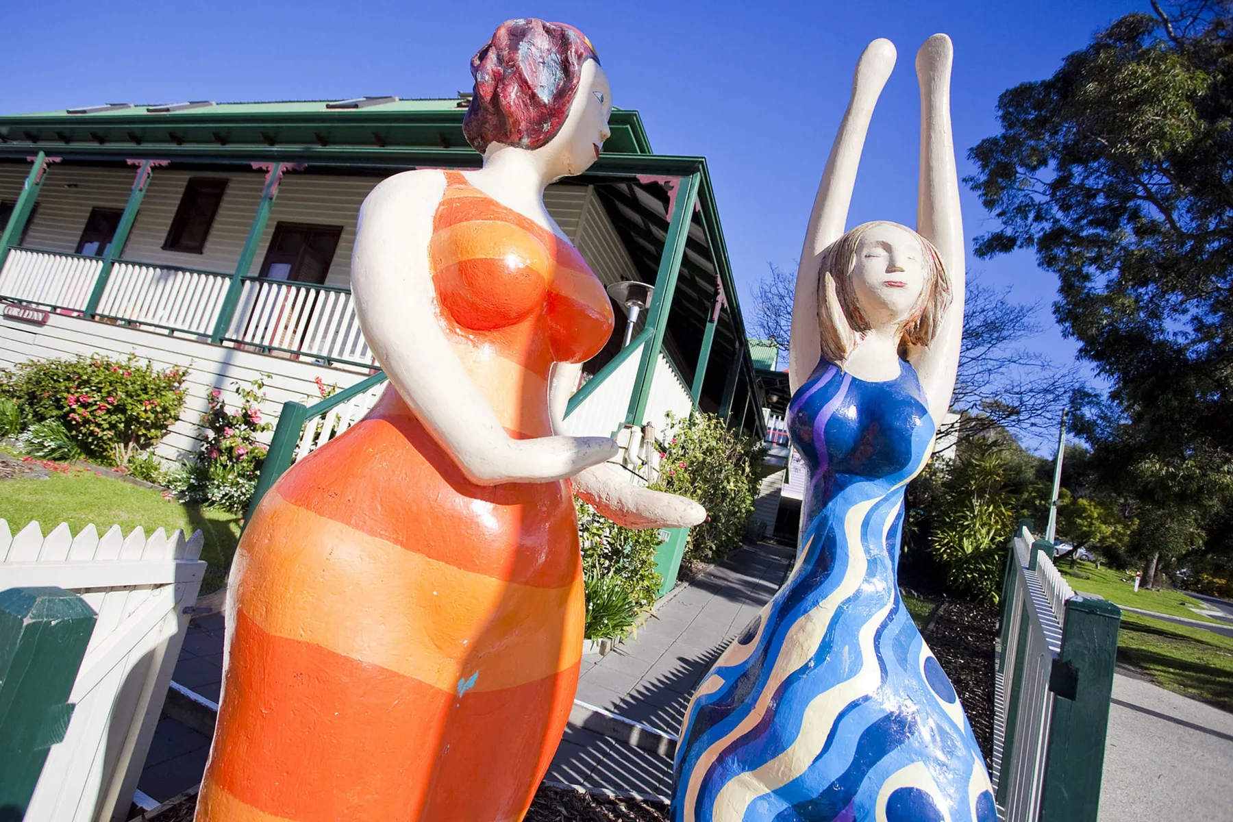 Shared amenity: A walkway passes between colorful statues in front of a building.