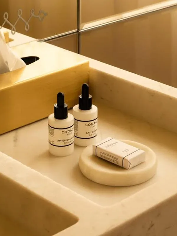 Representative hotel space: A bathroom vanity with toiletries arranged beside the sink.