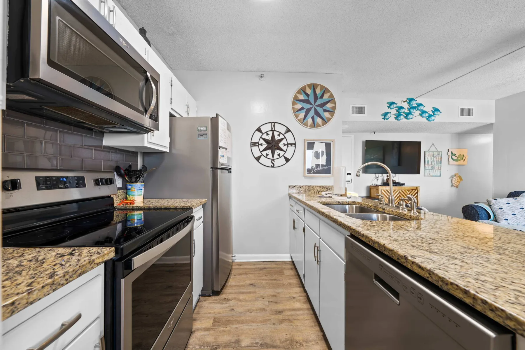Kitchen with a long island, sink, and stainless steel appliances.
