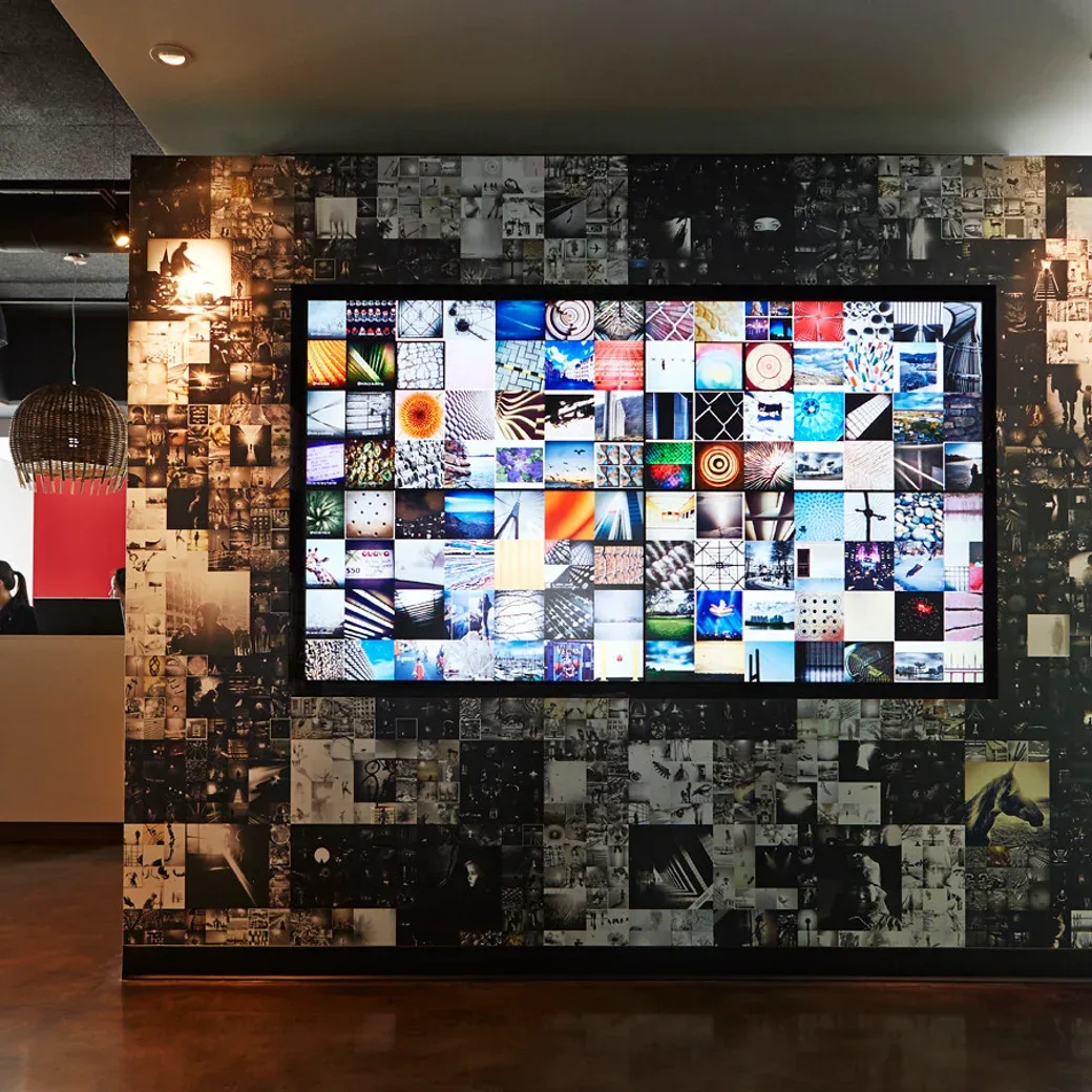 Representative hotel space: A gallery room features a large digital display surrounded by image collages.