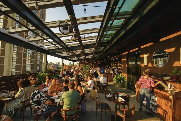 Representative hotel space: A busy outdoor dining area sits beneath a glass canopy.