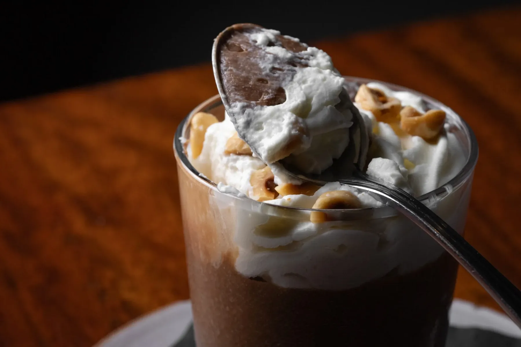 Representative hotel space: A chocolate dessert topped with whipped cream and nuts sits in a glass.