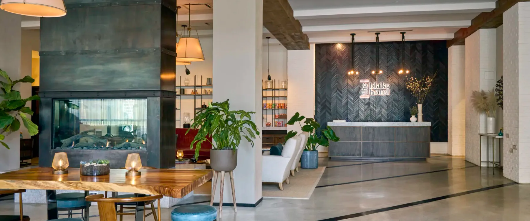 Representative hotel space: A hotel lobby with a reception desk, seating, and indoor plants.