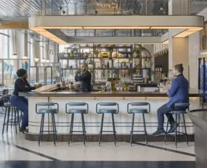 Representative hotel space: A modern bar area with seating around a long counter.