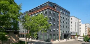 Representative hotel space: Street view of a multi-story building with trees along the sidewalk.