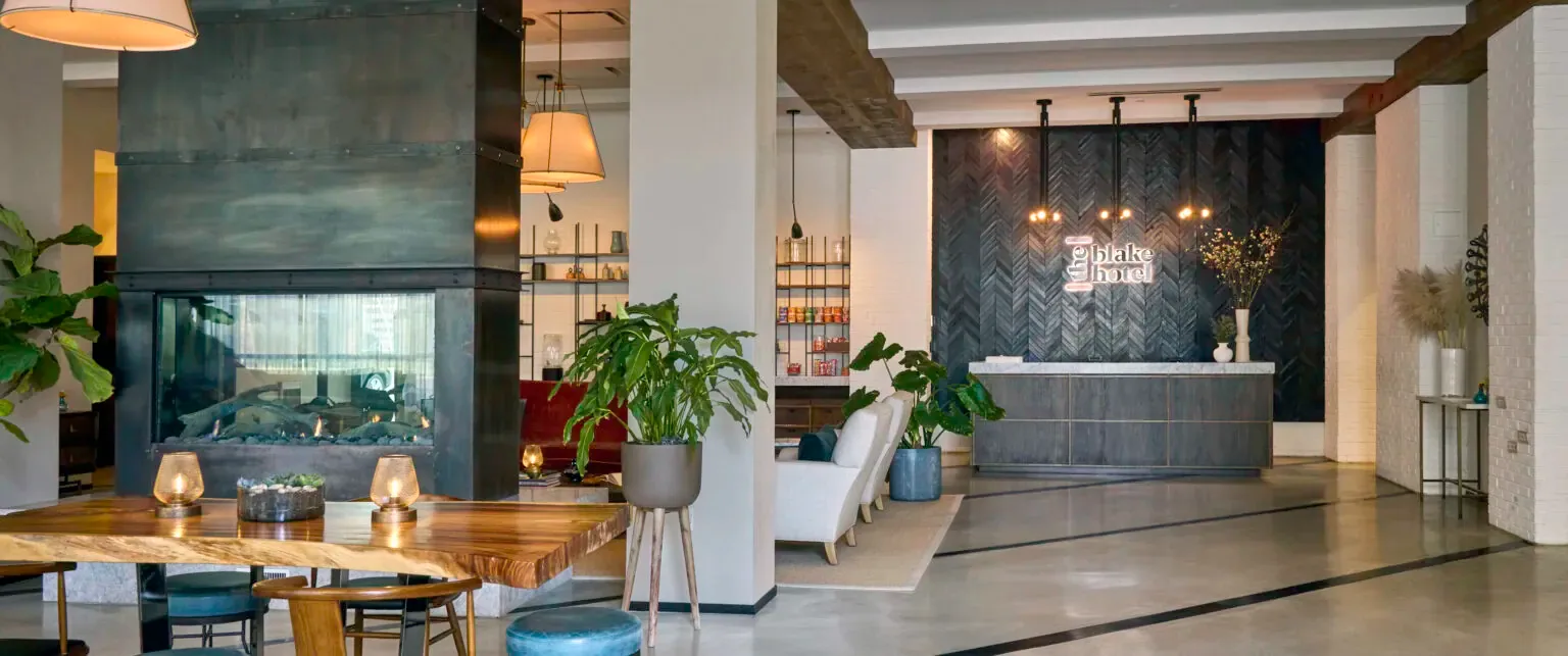 Representative hotel space: Hotel lobby with a reception desk, seating, and indoor plants.