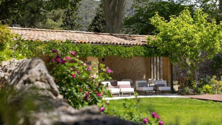 Representative hotel space: An outdoor patio with seating overlooks a green garden.