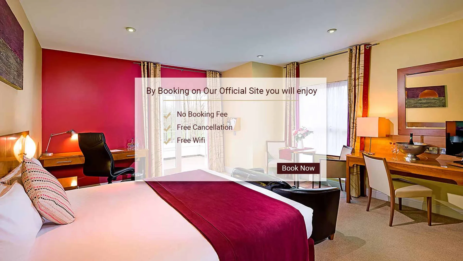 Representative hotel space: A bedroom with a large bed, desk, and seating beside bright windows.