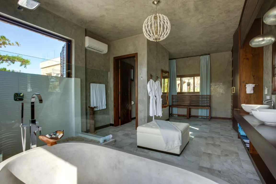 A spacious bathroom with a freestanding tub, walk-in shower, and vanity.
