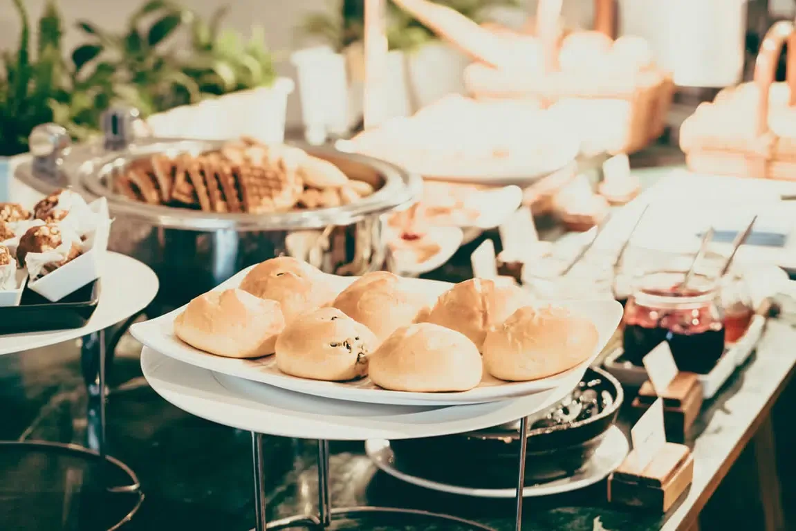 Representative hotel space: A buffet table displays bread, pastries, and serving dishes.