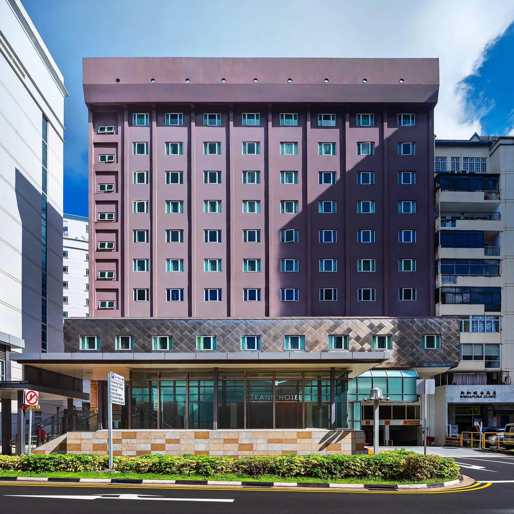Representative hotel space: A multistory hotel building stands beside neighboring urban buildings.