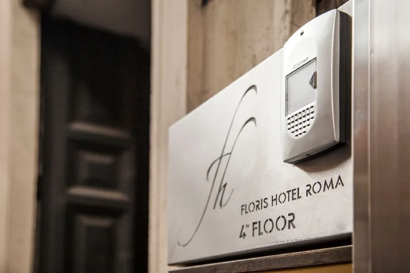 Representative hotel space: A hotel sign marks the fourth floor beside an intercom.