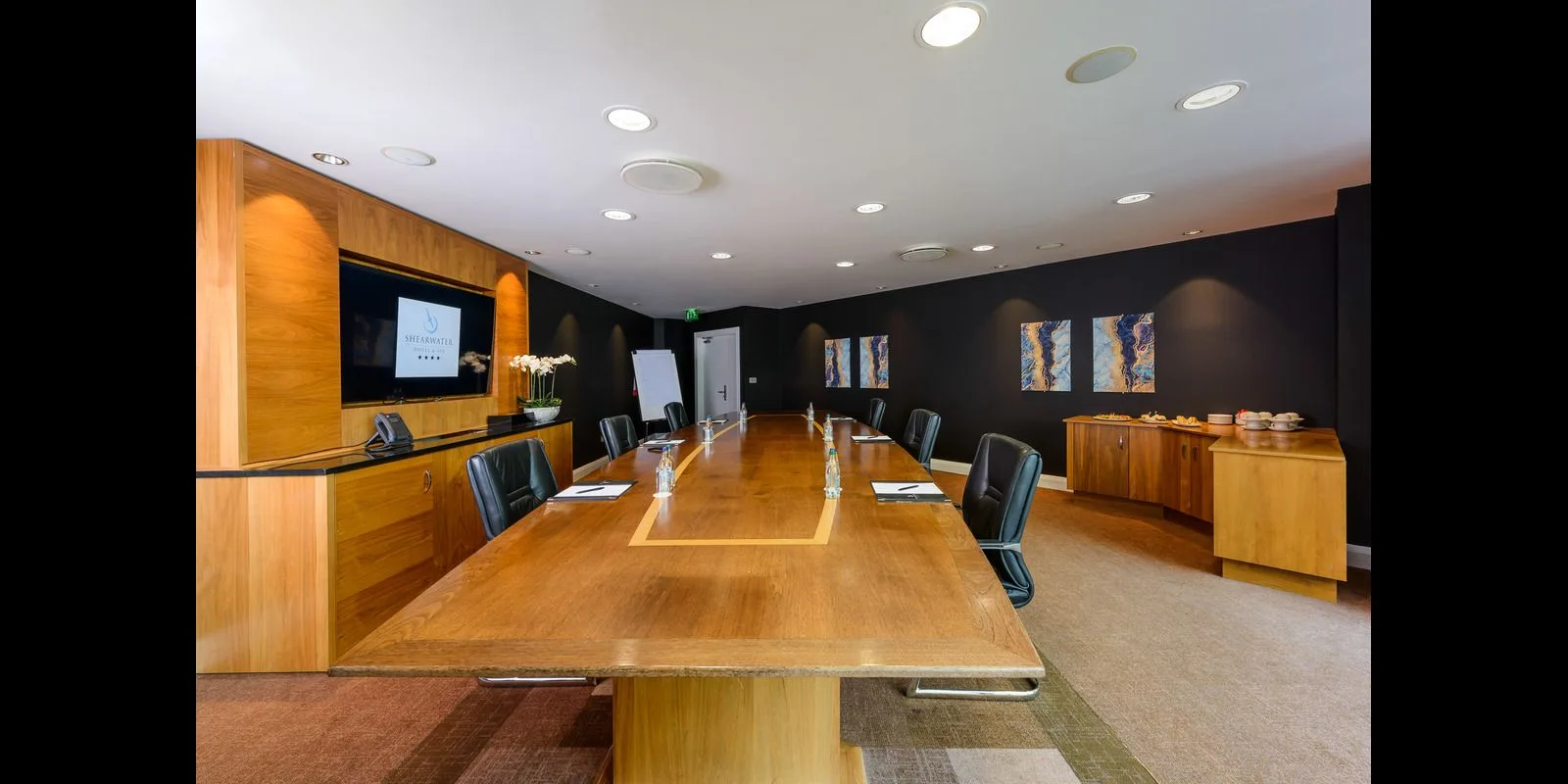 Representative hotel space: A conference room with a long wooden table and chairs.