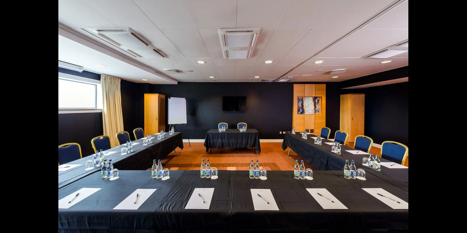 Representative hotel space: A conference room arranged with tables and chairs.