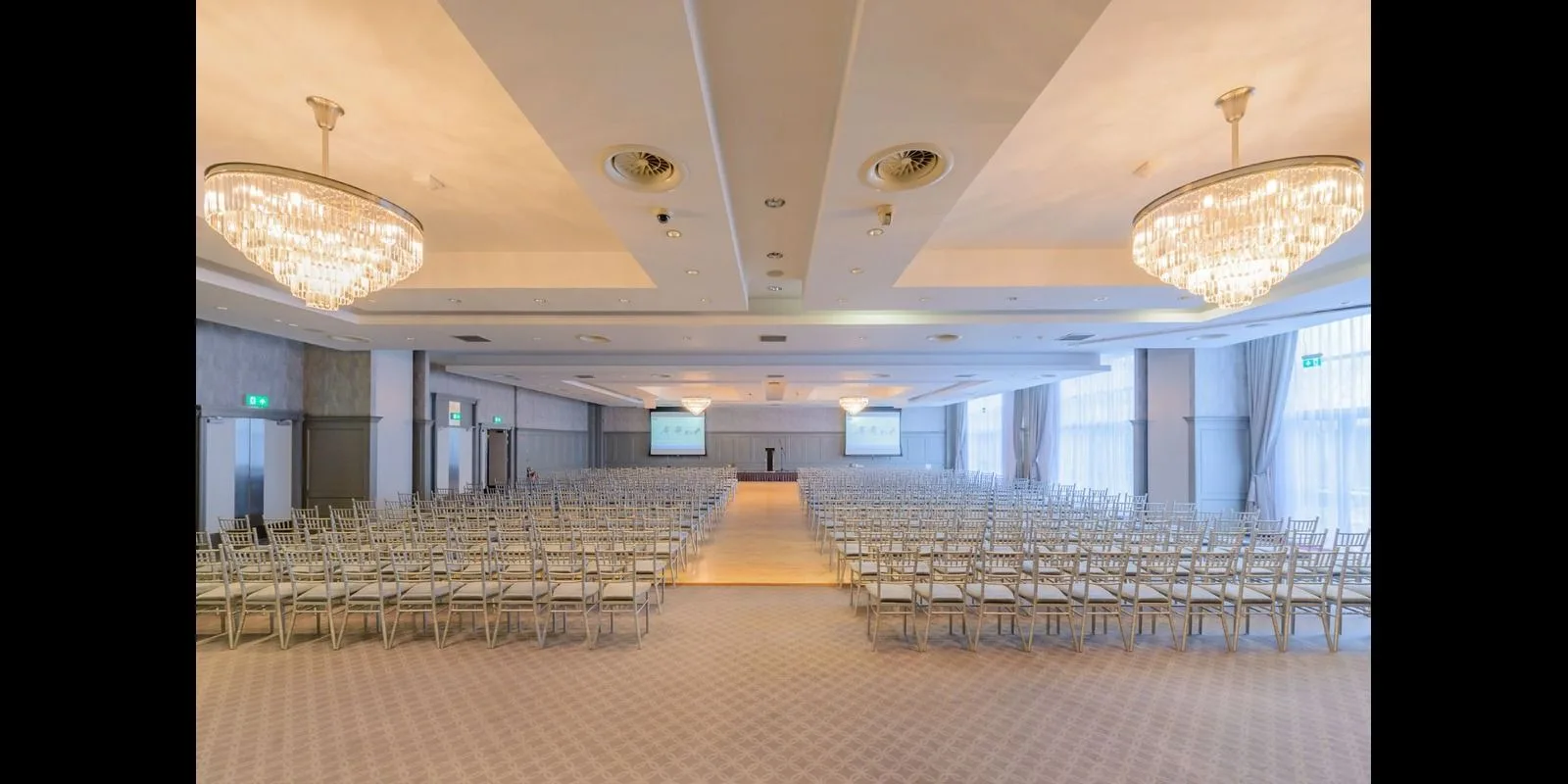 Representative hotel space: A large event hall is arranged with rows of chairs facing a stage.