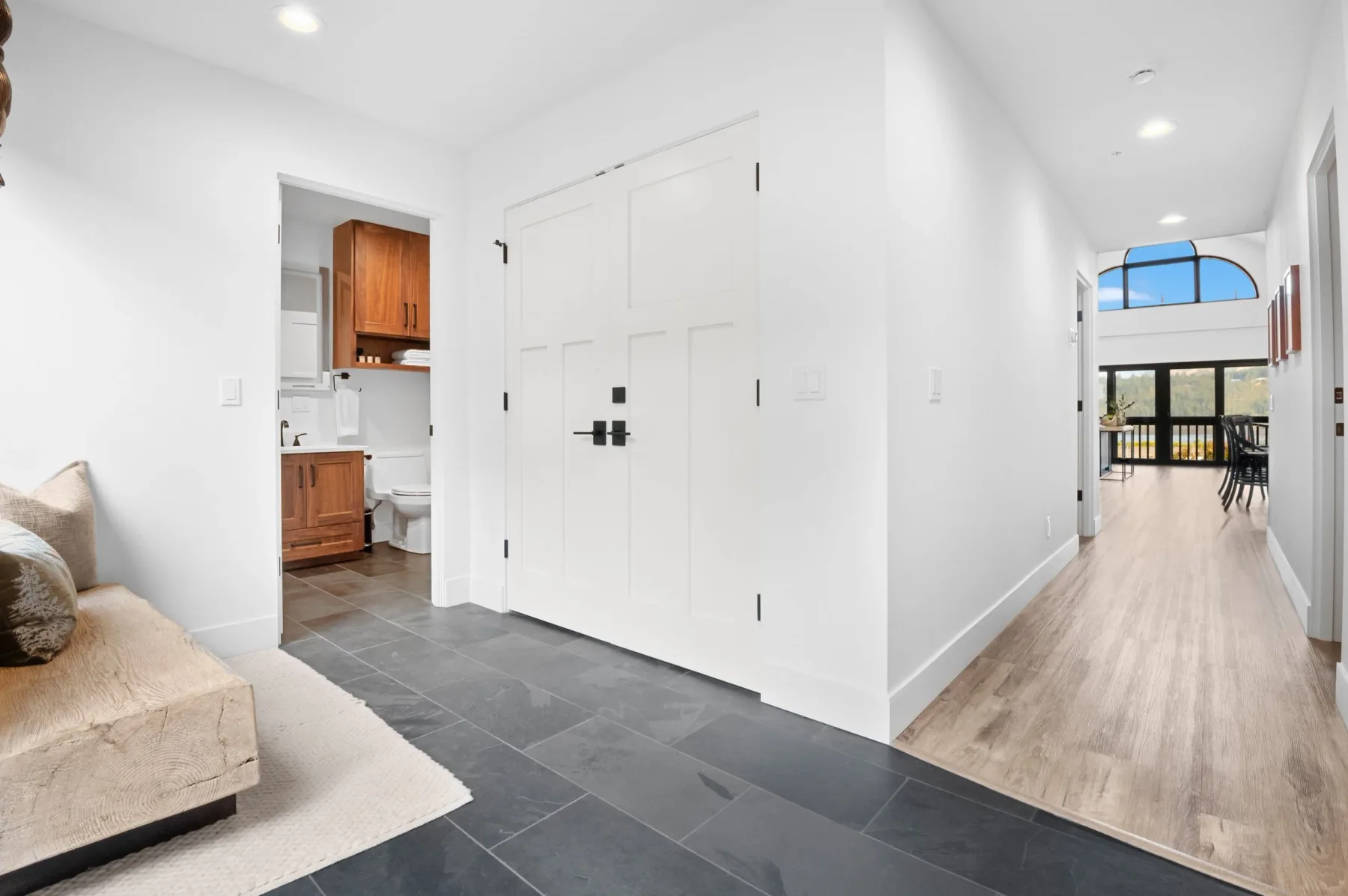 Representative hotel space: A bright hallway connects a tiled entry area with an open kitchen and dining space.