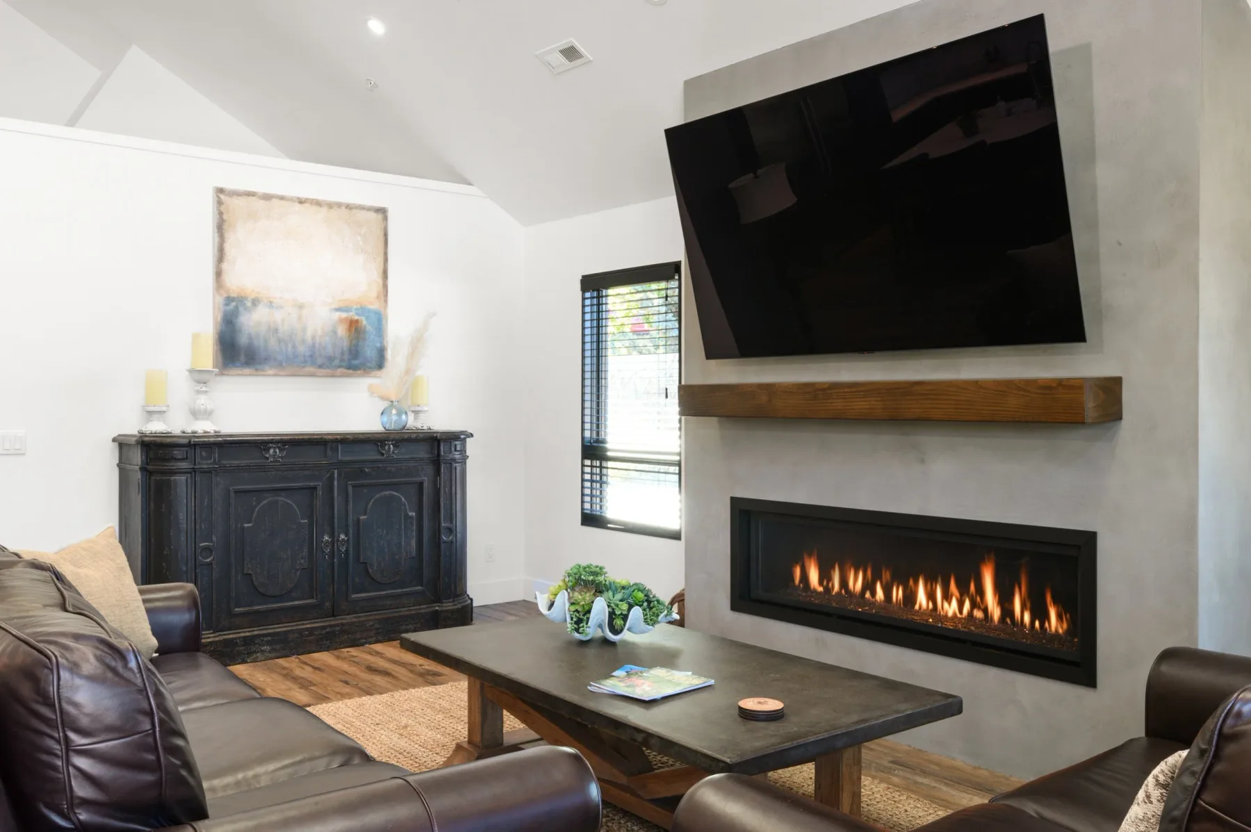 Representative hotel space: A living room with a fireplace, wall-mounted television, and seating.