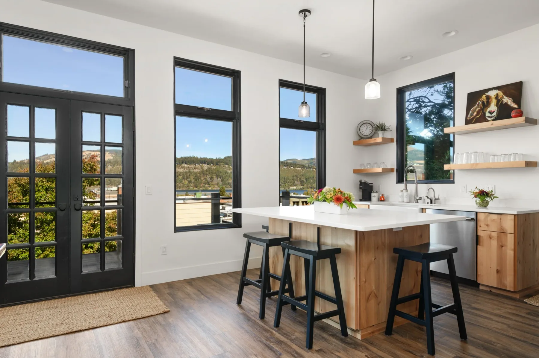 Representative hotel space: Bright kitchen with a central island, bar seating, and large windows.
