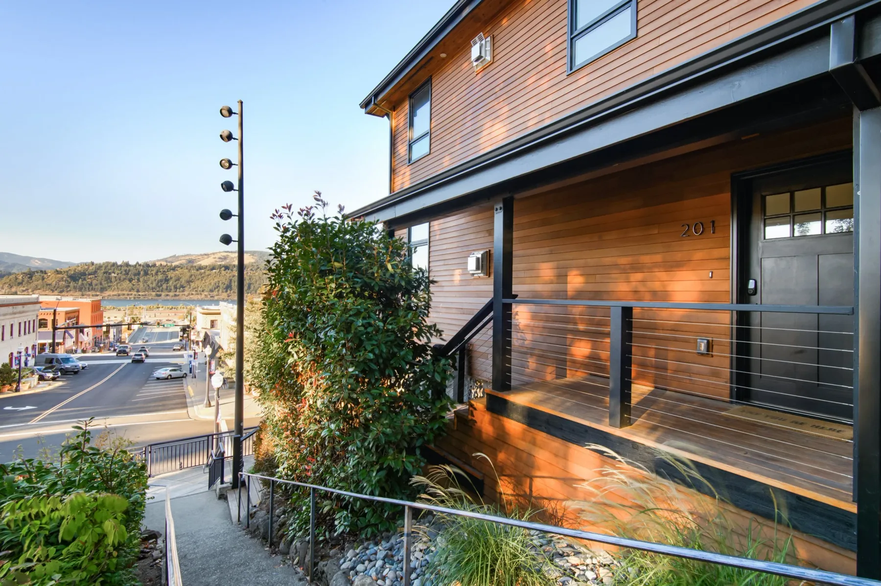 Representative hotel space: A wooden-sided building entrance opens onto a raised porch overlooking a town street.