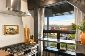 Representative hotel space: A kitchen with a large window overlooking a distant landscape.