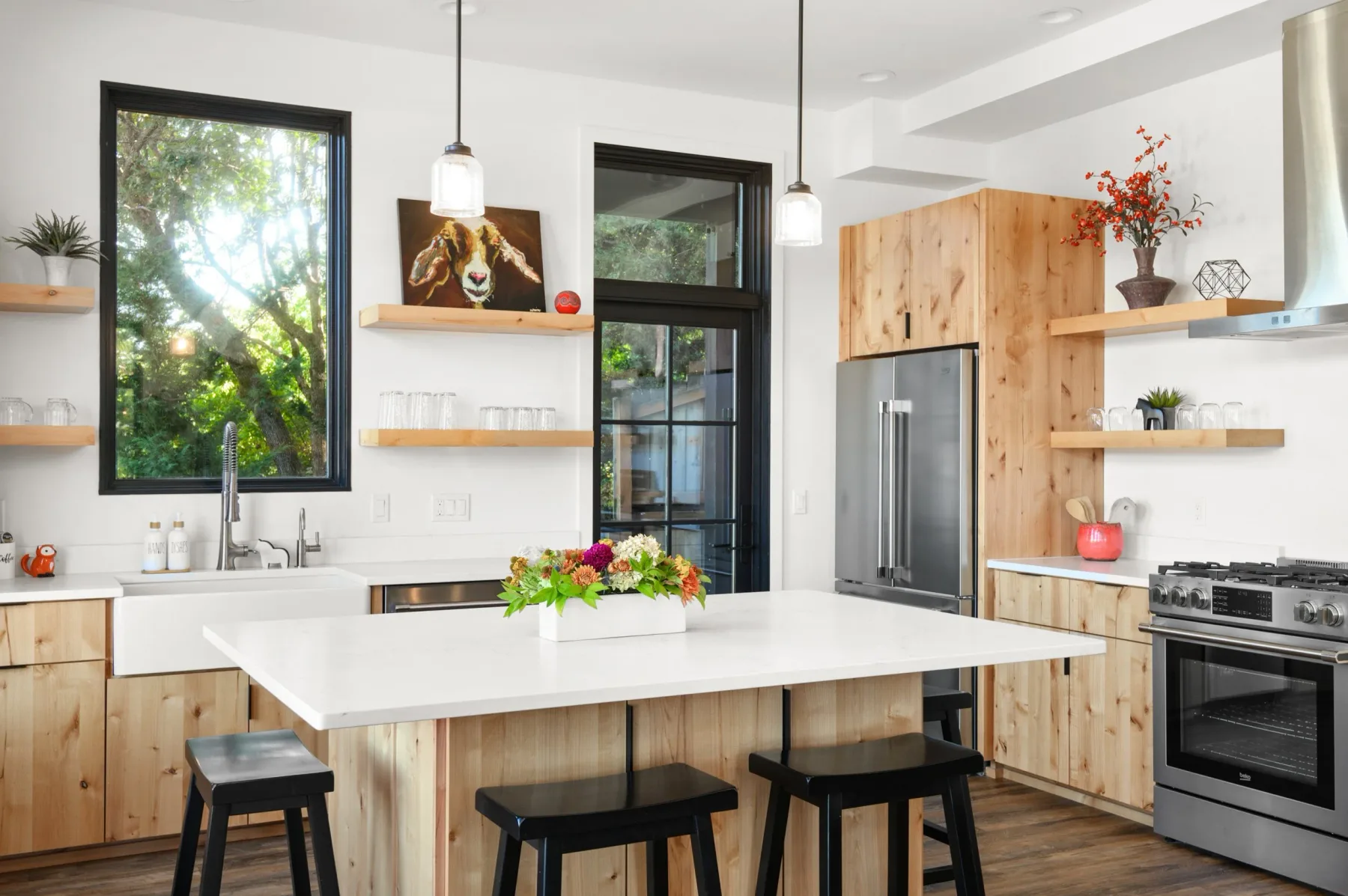 Representative hotel space: A bright kitchen with a large island and wood cabinetry.