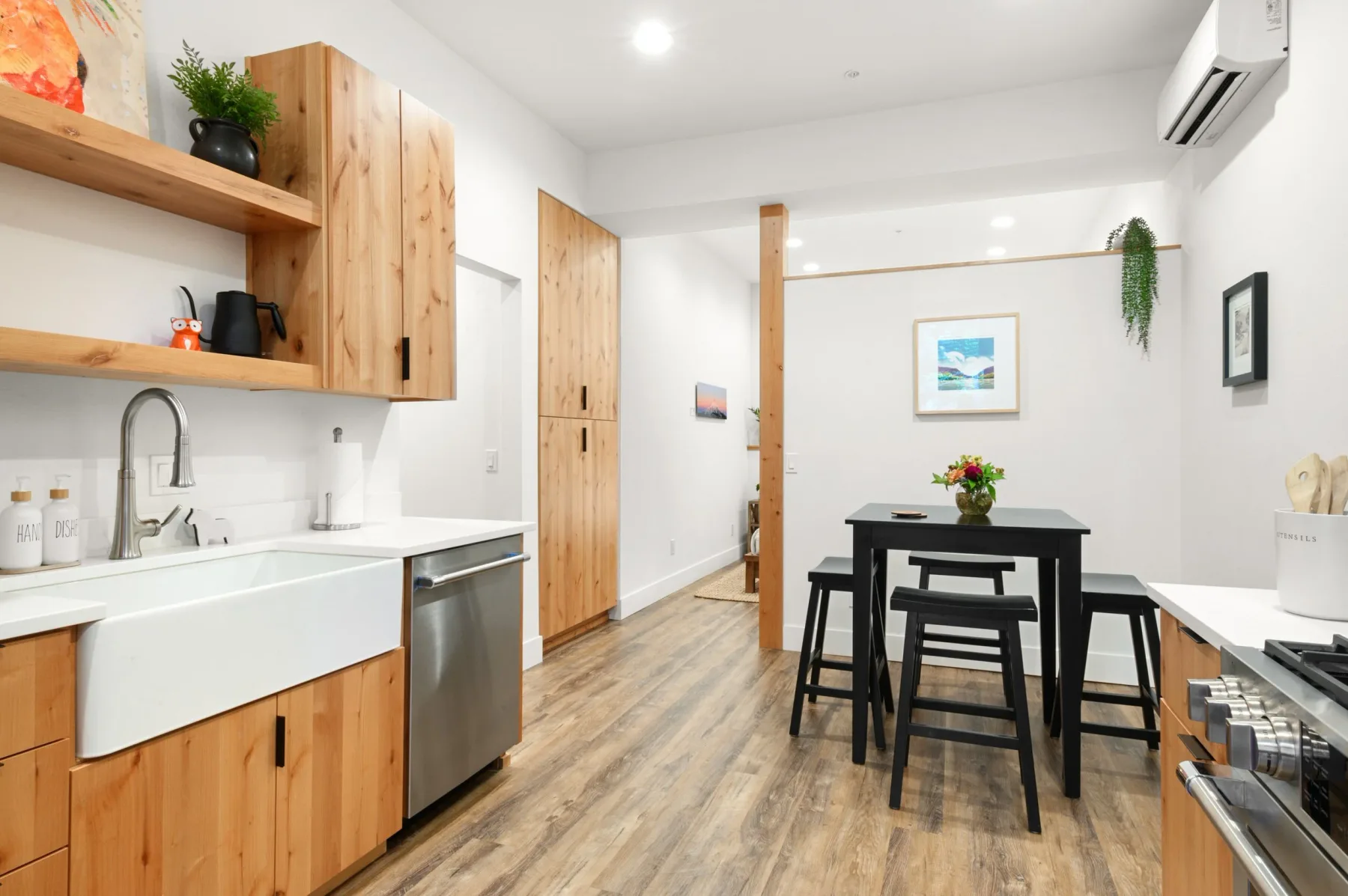 Representative hotel space: A compact kitchen and dining area with wood cabinetry and a table.
