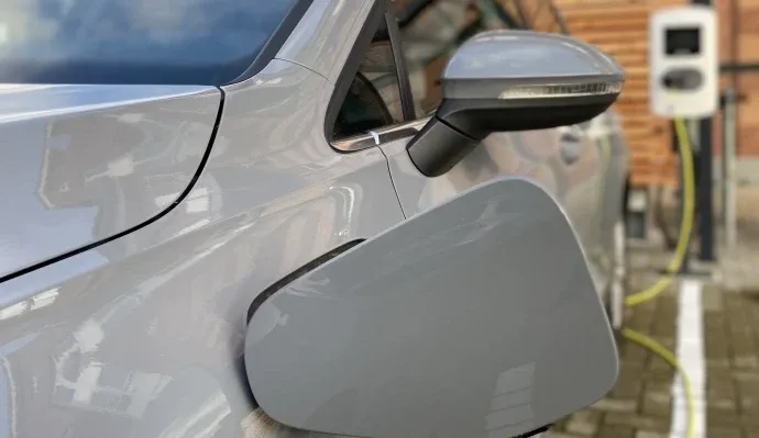 Representative hotel space: A close-up of an electric car charging beside a charging station.