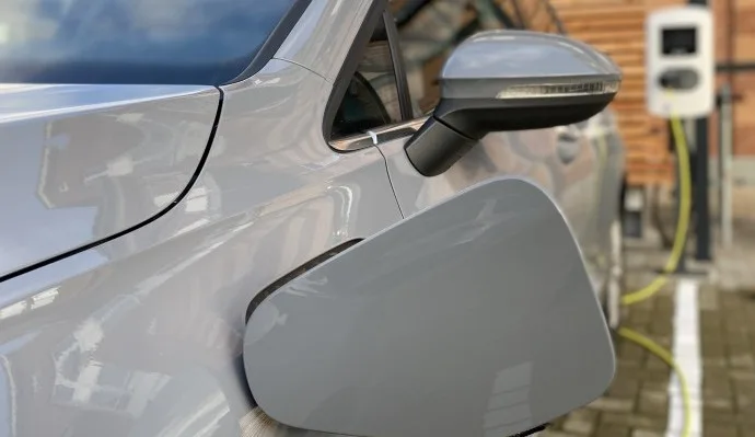 Representative hotel space: A parked electric car is connected to a charging station.