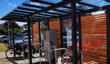 Representative hotel space: An outdoor parking area with bicycle racks beneath a covered structure.