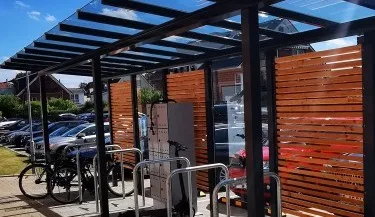 Representative hotel space: A covered outdoor bicycle parking area with wooden slatted screens.