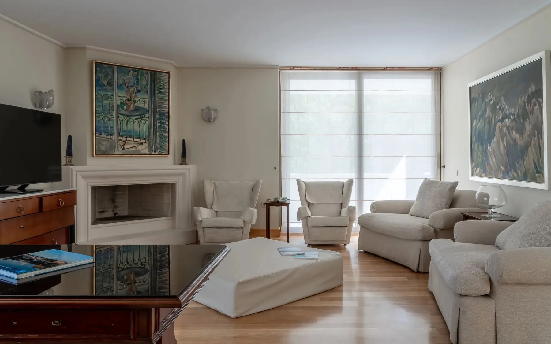 A bright living room with seating arranged around a low coffee table.