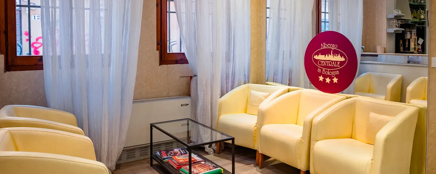 Representative hotel space: A hotel lounge with pale upholstered seating and a glass coffee table.