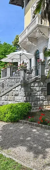 Representative hotel space: An outdoor terrace with umbrellas sits above a stone retaining wall.
