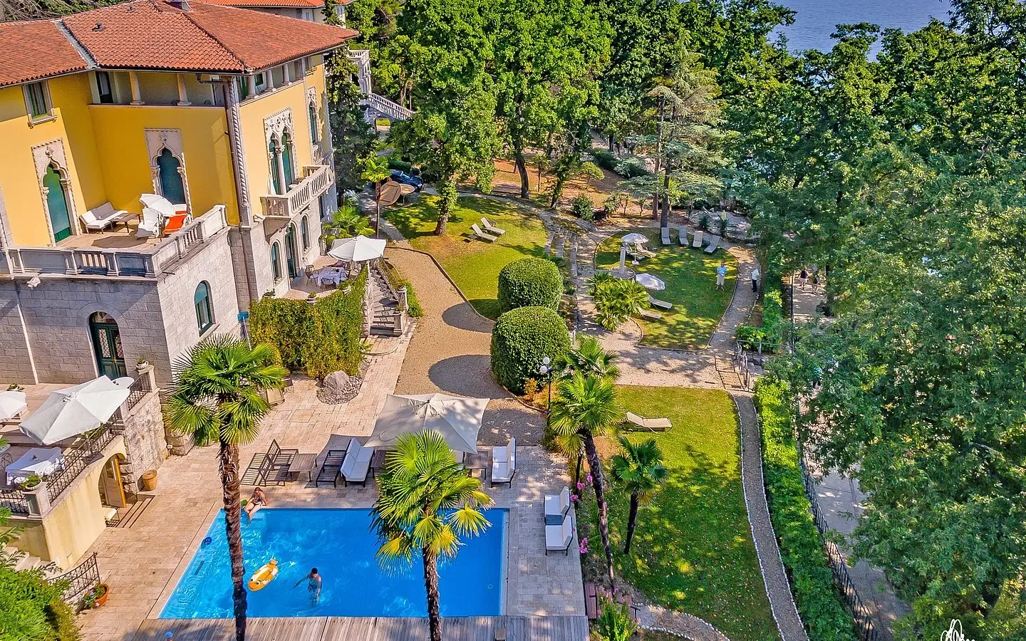 Representative hotel space: Aerial view of a hotel courtyard with a swimming pool and garden paths.