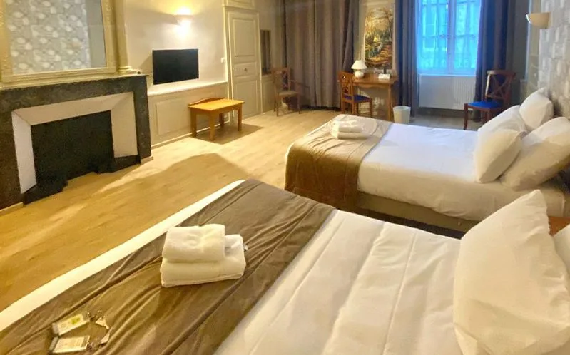 Representative hotel space: A bedroom with two beds, a fireplace, and a television.
