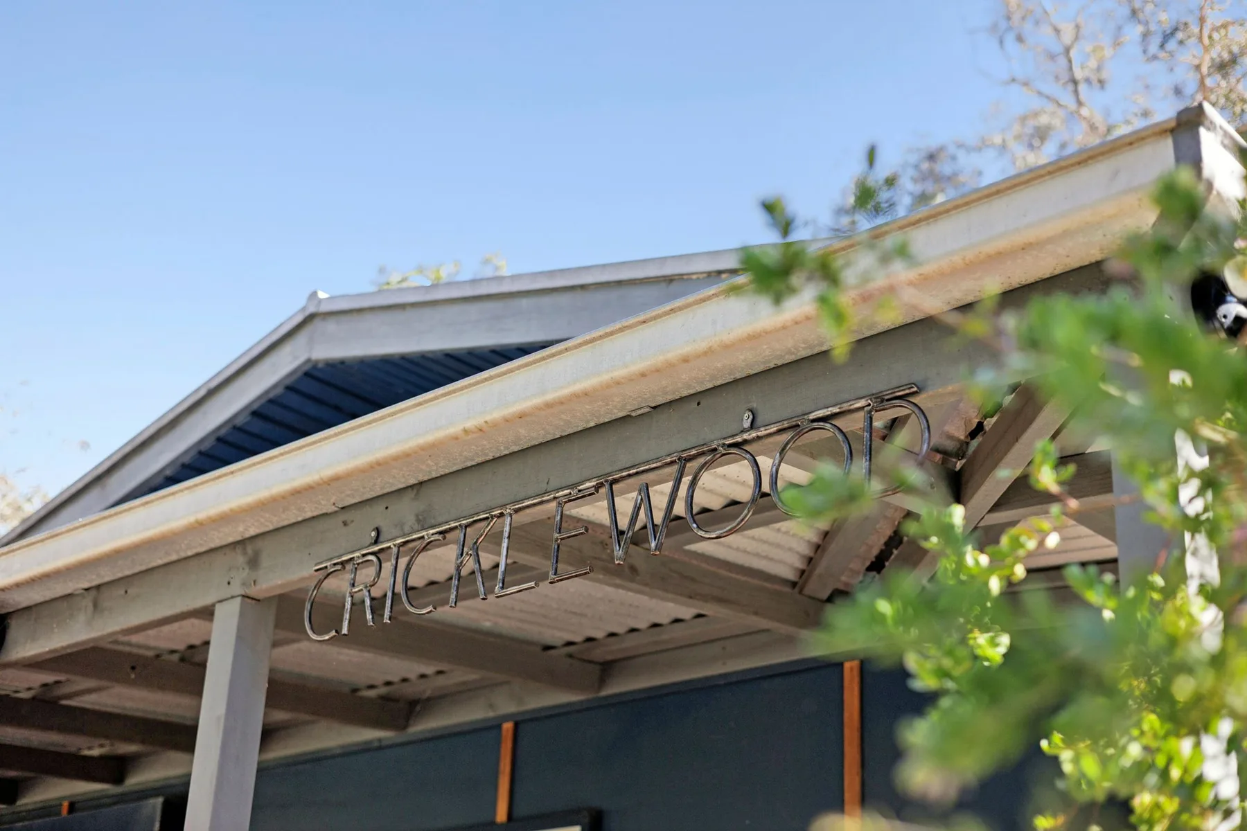 A building entrance beneath a covered awning with a sign above the doorway.