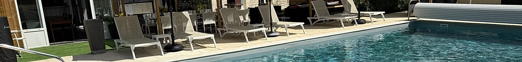 Espacio representativo del hotel: Una piscina al aire libre con asientos junto a la terraza.